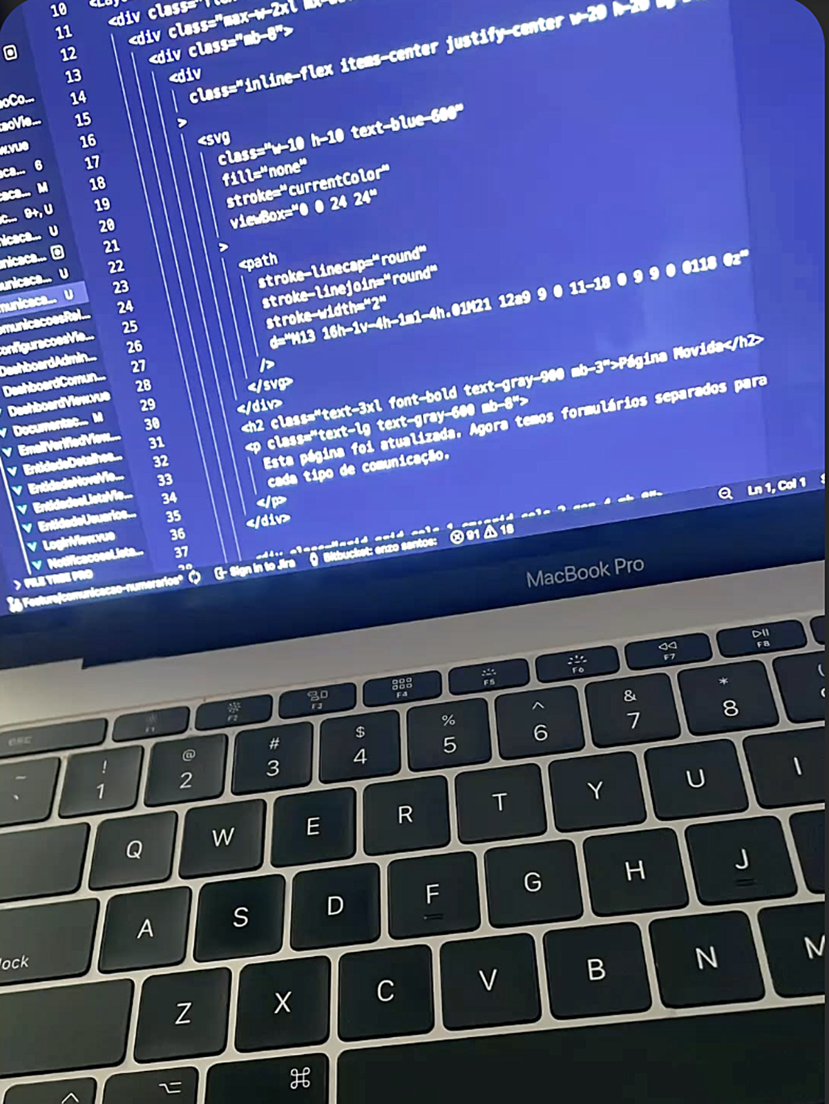 An open laptop displaying programming code in a code editor